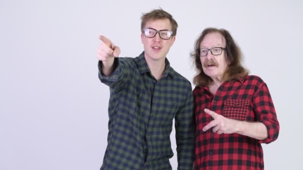 Happy senior hipster man and young hipster man smiling and found something — Stock Video