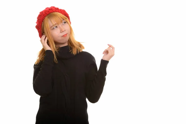 Young cute pensive Asian woman wearing hat while thinking — Stock Photo, Image