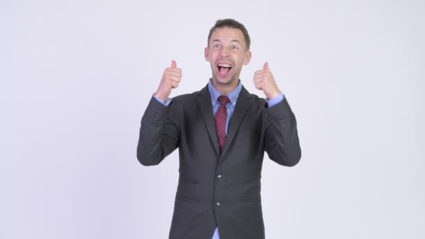 Studio shot of happy businessman looking excited while giving thumbs up — Stock Video