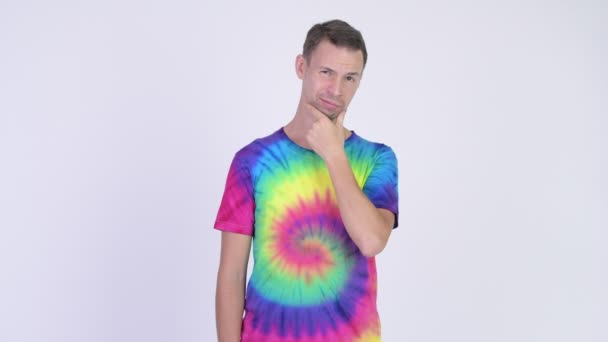 Estúdio tiro de homem com tie-dye camisa pensando — Vídeo de Stock