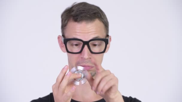 Studio shot of happy nerd man jouer avec fidget spinner — Video