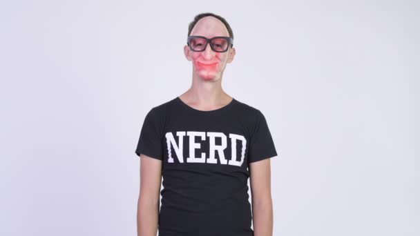 Studio shot of nerd man wearing scary mask and eyeglasses — Stock Video