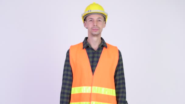 Studio shot of happy man construction worker smiling — Stock Video