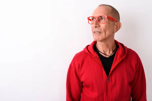 Studio skott av skallig senior man tänker iklädd glasögon — Stockfoto