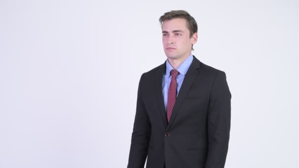 Young happy handsome businessman looking excited while giving thumbs up — Stock Video