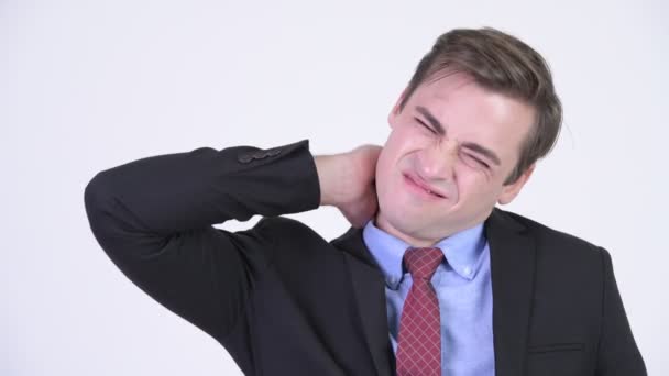 Young stressed businessman having neck pain — Stock Video