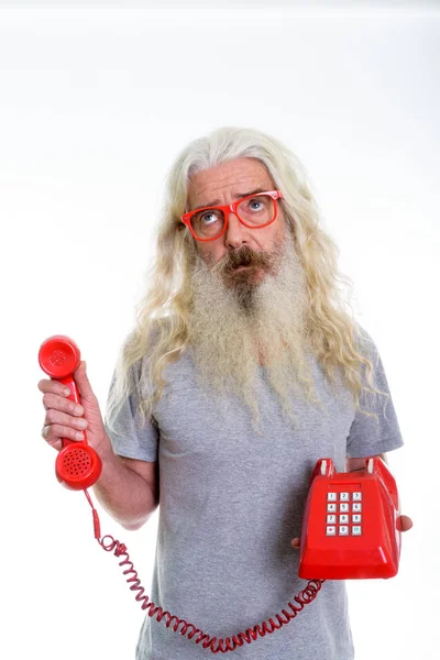 Studio shot of senior bearded man thinking and looking up while — Stock Photo, Image