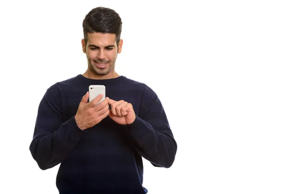 Young happy Persian man smiling and using mobile phone touching — Stock Photo, Image