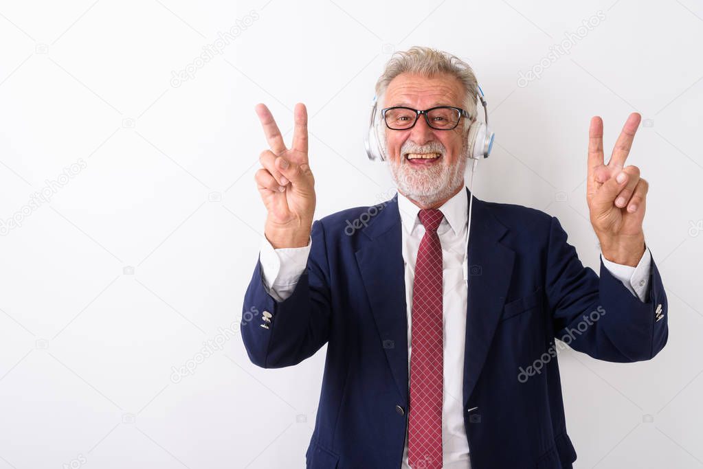 Studio shot of happy senior bearded businessman smiling and givi