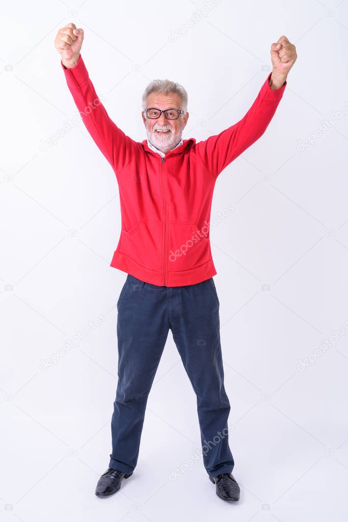 Full body shot of happy senior bearded man smiling while standin