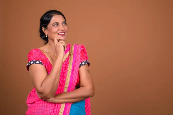 Mulher indiana feliz vestindo Sari roupas tradicionais indianas e pensando — Fotografia de Stock