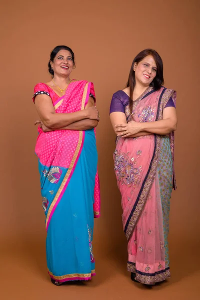 Two mature Indian women wearing Sari Indian traditional clothes