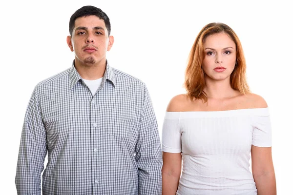 Studio shot of young Hispanic couple looking at camera together — Stock Photo, Image