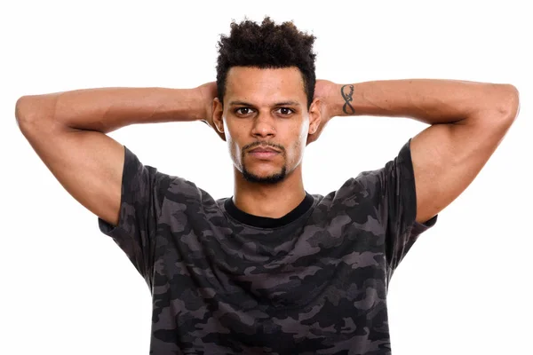 Studio shot of young African man with both hands behind back of — Stock Photo, Image