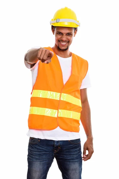 Young happy African man construction worker smiling while pointi — Stock Photo, Image