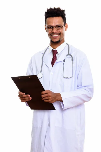 Young happy African man doctor smiling while holding clipboard — Stock Photo, Image