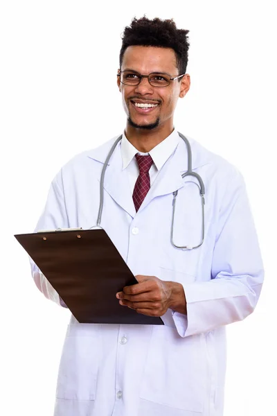 Young happy African man doctor smiling while holding clipboard a — Stock Photo, Image