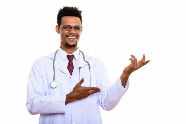 Młody szczęśliwy Afryki człowiek lekarz uśmiecha się a pokazując coś — Zdjęcie stockowe