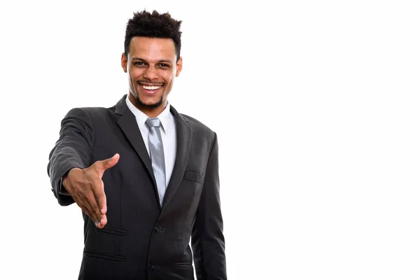 Joven empresario africano feliz sonriendo mientras da apretón de manos — Foto de Stock