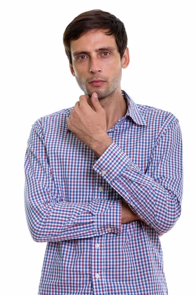 Studio shot of young handsome businessman thinking — Stock Photo, Image