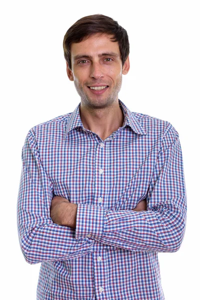 Studio shot of young happy businessman smiling with arms crossed — Stock Photo, Image