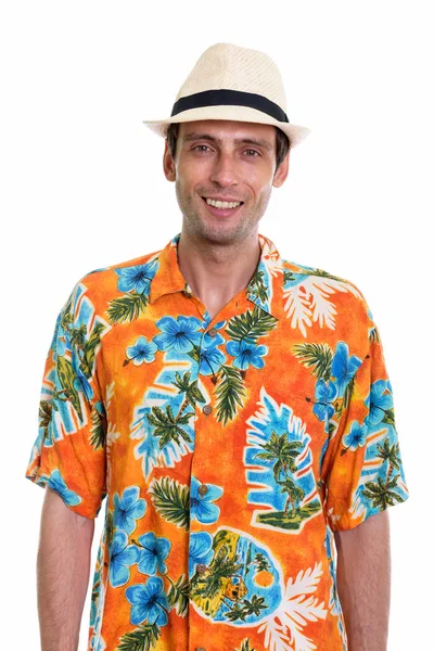 Studio shot of young happy tourist man smiling ready for vacatio — Stock Photo, Image