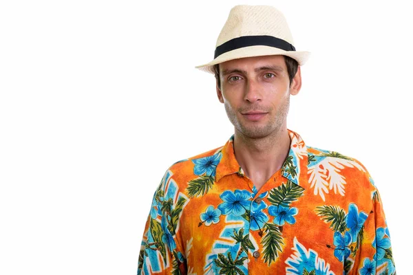 Studio shot of young handsome tourist man wearing hat and Hawaii — Stock Photo, Image