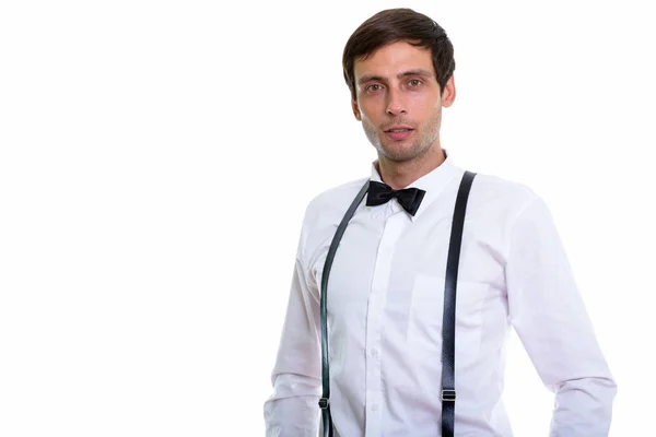 Studio shot of young handsome man wearing suspenders and bow tie — Stock Photo, Image