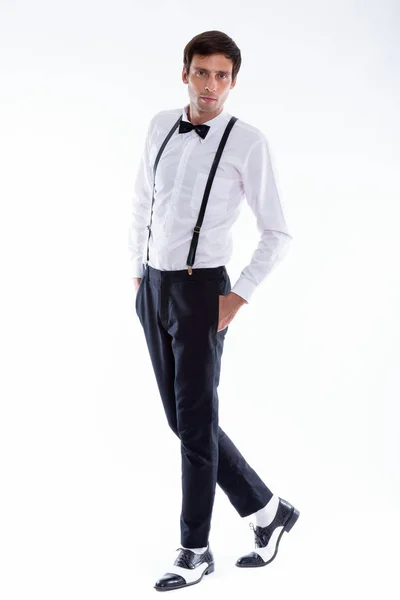 Full body shot of young handsome man wearing suspenders and bow — Stock Photo, Image