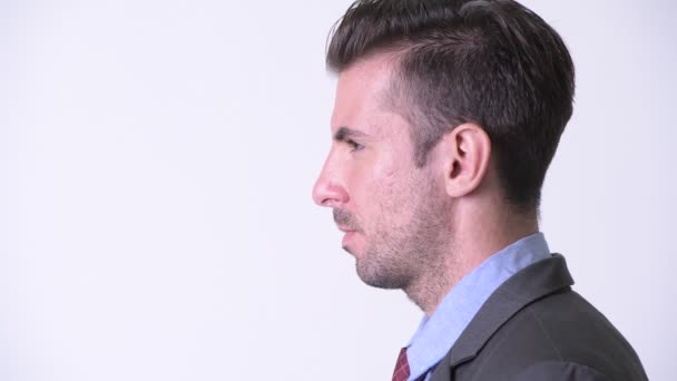 Profile view of young handsome Hispanic businessman — Stock Video