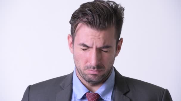 Head shot of young sad Hispanic businessman crying — Stock Video