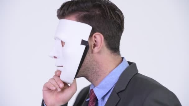 Young handsome Hispanic businessman revealing face — Stock Video