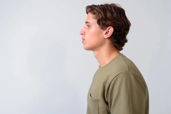 Young handsome man with wavy hair against white background — Stock Photo, Image