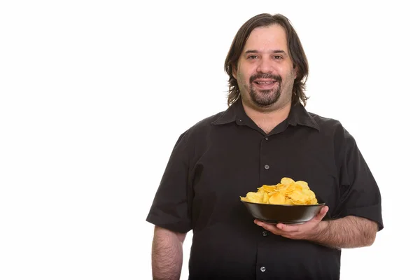 Happy fat Caucasian man smiling and holding bowl of chips — Stock Photo, Image