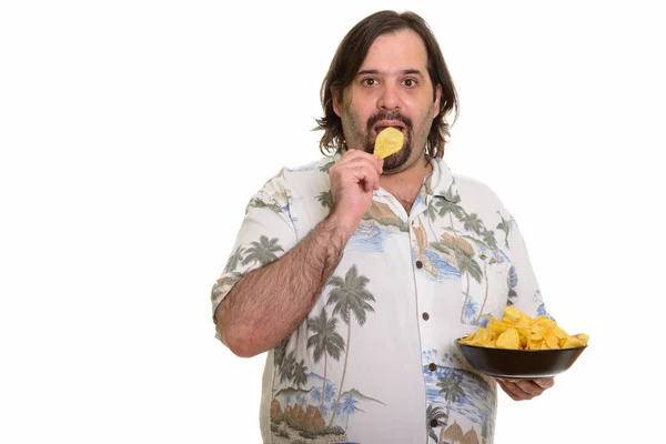 Portrait of fat bearded Caucasian man eating chips — Stock Photo, Image