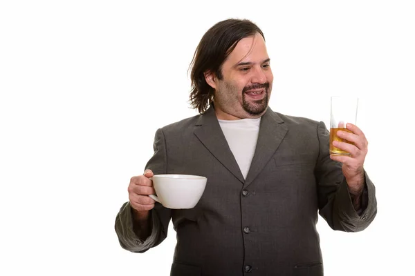 Happy fat Caucasian businessman smiling and choosing beer over c — Stock Photo, Image
