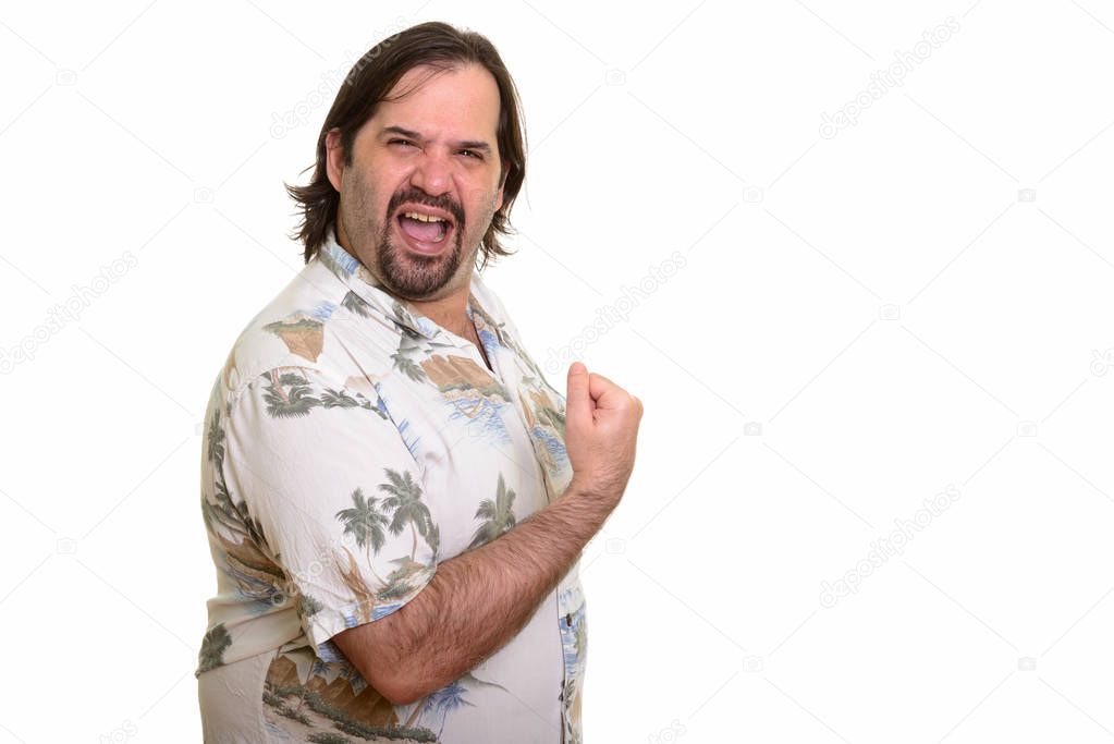 Happy fat Caucasian man smiling and looking motivated with arm r