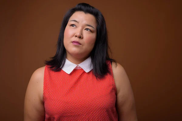 Beautiful overweight Asian woman thinking and looking up — Stock Photo, Image