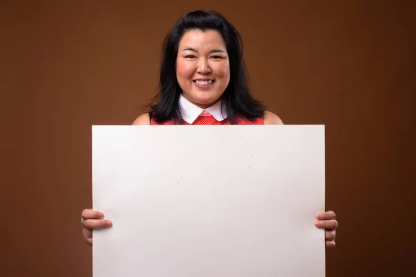 Mujer feliz con sobrepeso sosteniendo tablero blanco vacío con espacio de copia —  Fotos de Stock