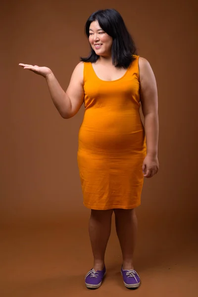 Studio Skott Vackra Överviktiga Asiatisk Kvinna Bär Orange Ärmlös Klänning — Stockfoto