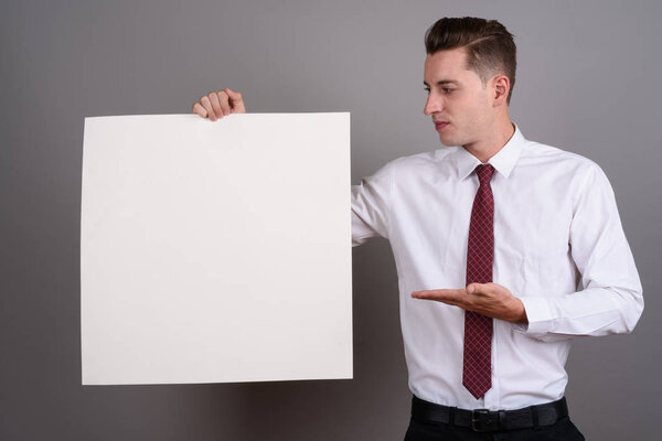 Businessman holding empty white board with copy space