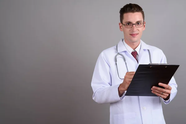 Portrét pohledný mladík lékaře drží schránky — Stock fotografie