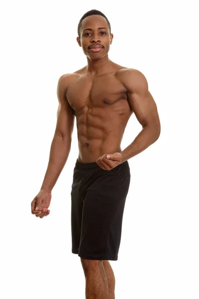 Jovem e bonito homem africano sem camisa flexionando o braço esquerdo — Fotografia de Stock