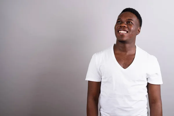 Portrait of young African man against white background — Stock Photo, Image