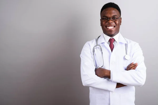 Young African man doctor against white background — Stock Photo, Image