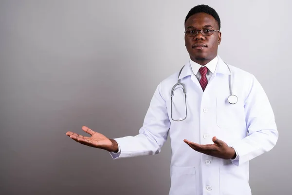 Young African man doctor against white background — Stock Photo, Image