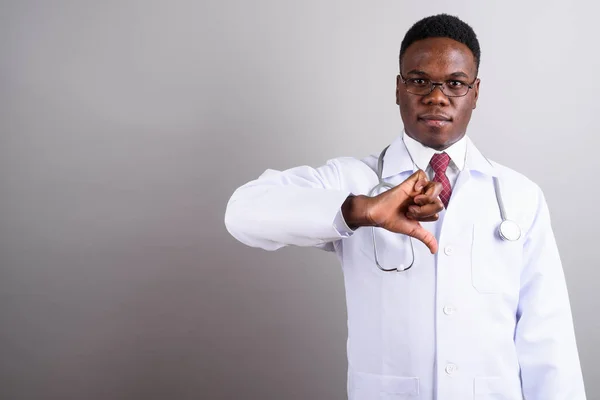 Young African man doctor against white background — Stock Photo, Image