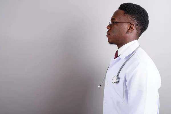 Young African man doctor against white background — Stock Photo, Image