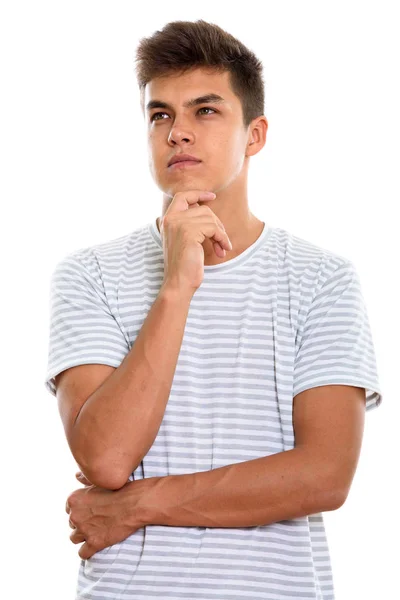 Studio shot of young handsome man thinking while looking up — Stock Photo, Image
