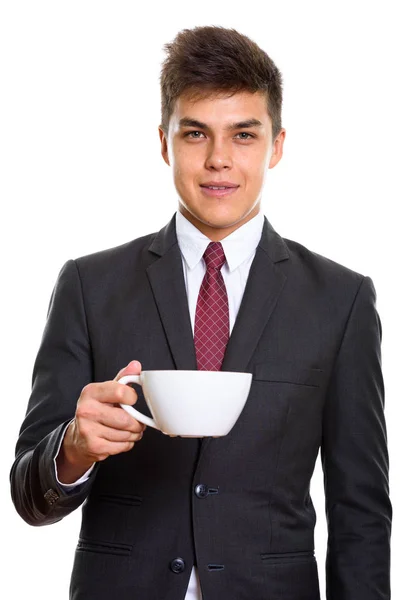 Studio shot of young handsome businessman holding coffee cup — Stock Photo, Image